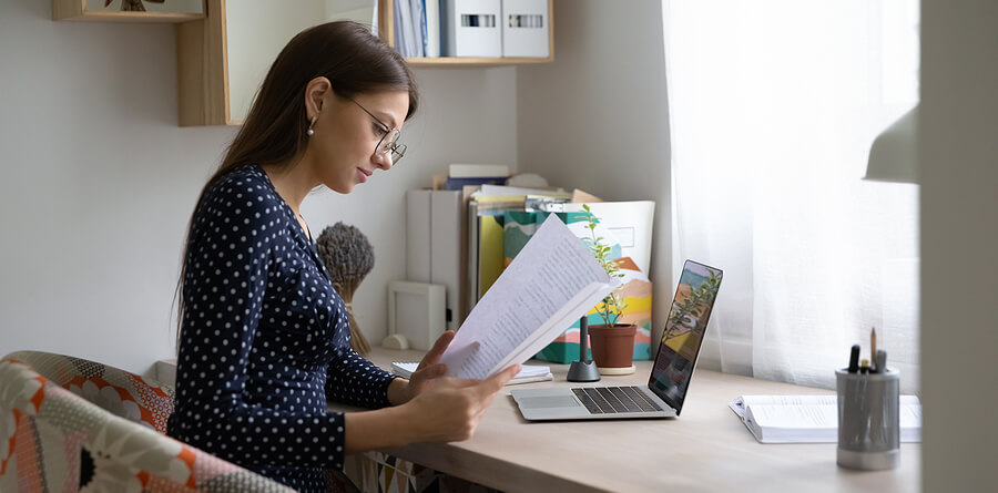 a woman reading personal loan terms at her desk