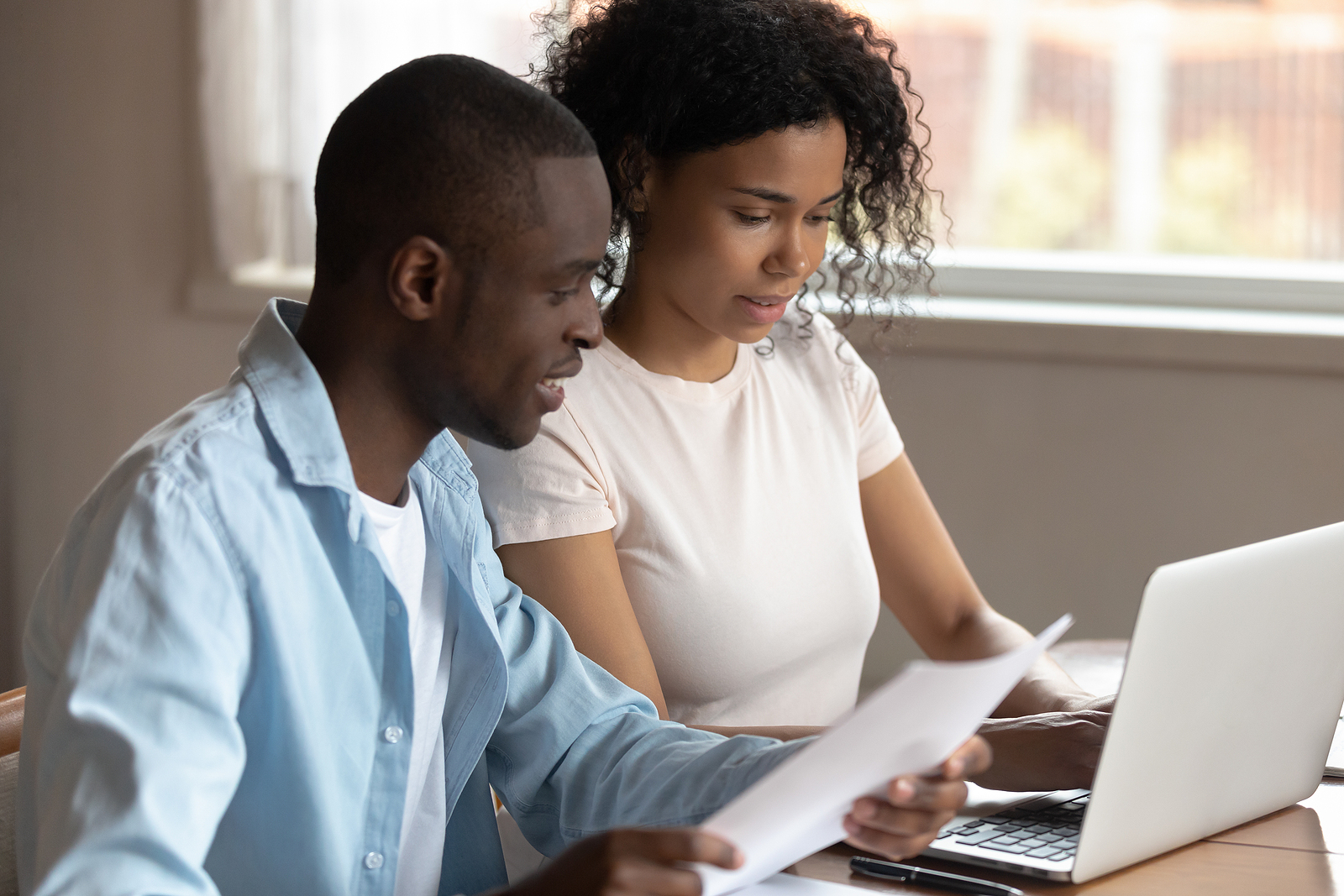 a couple reviews their finances in preparation to get a personal loan online