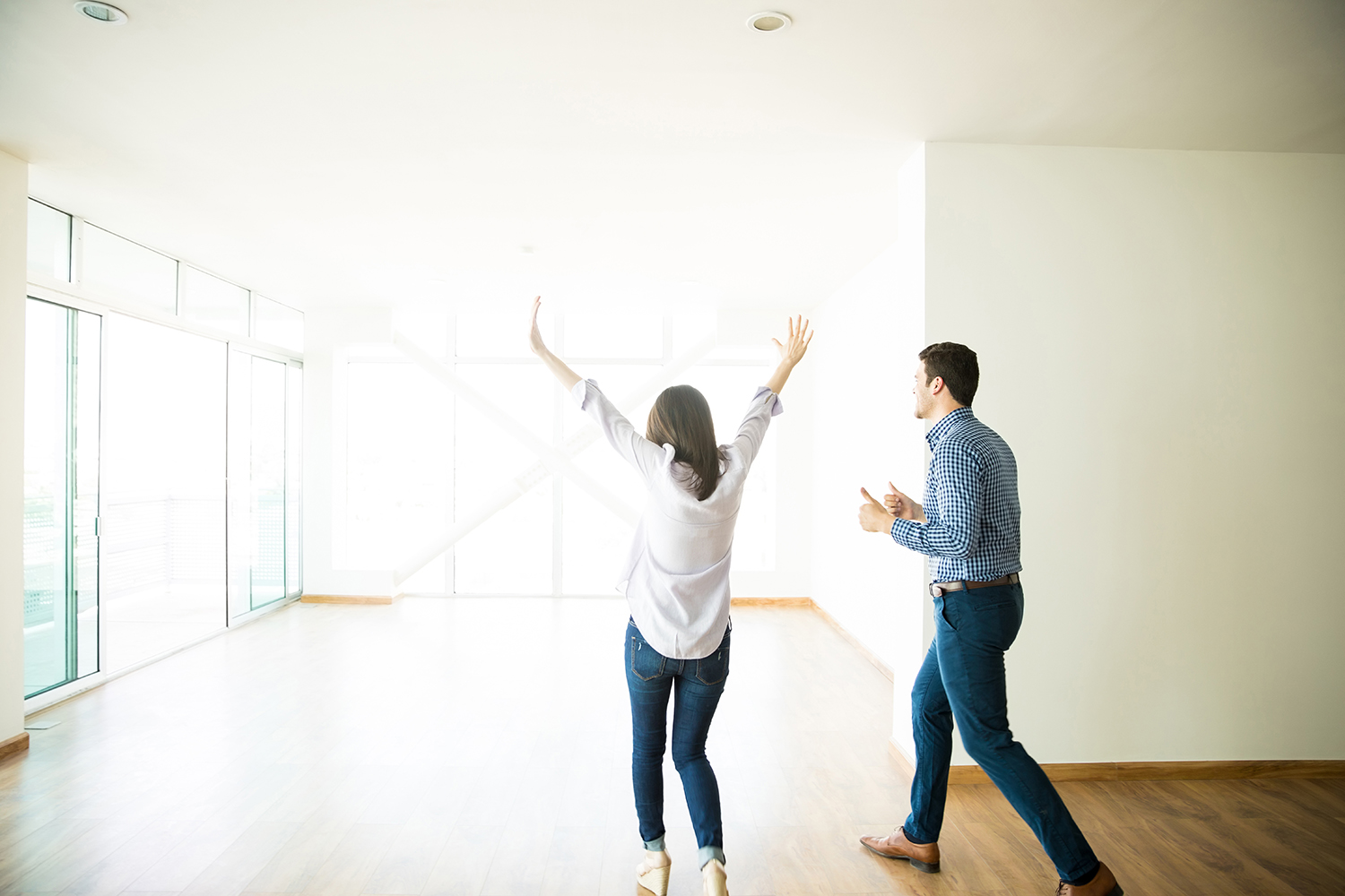 Excited Man And Woman Entering Empty Room In New Home