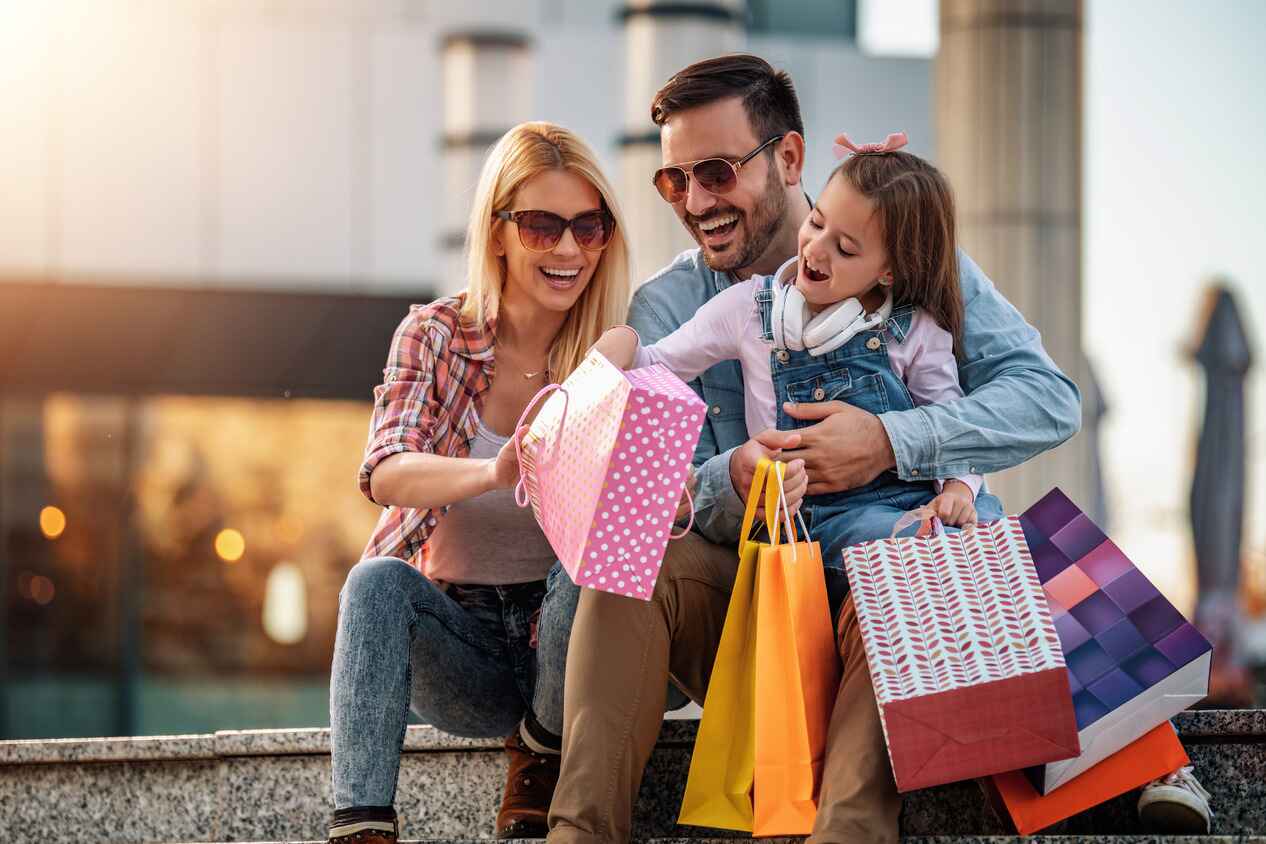 A family enjoys shopping using the debit card for their Premium Checking account.