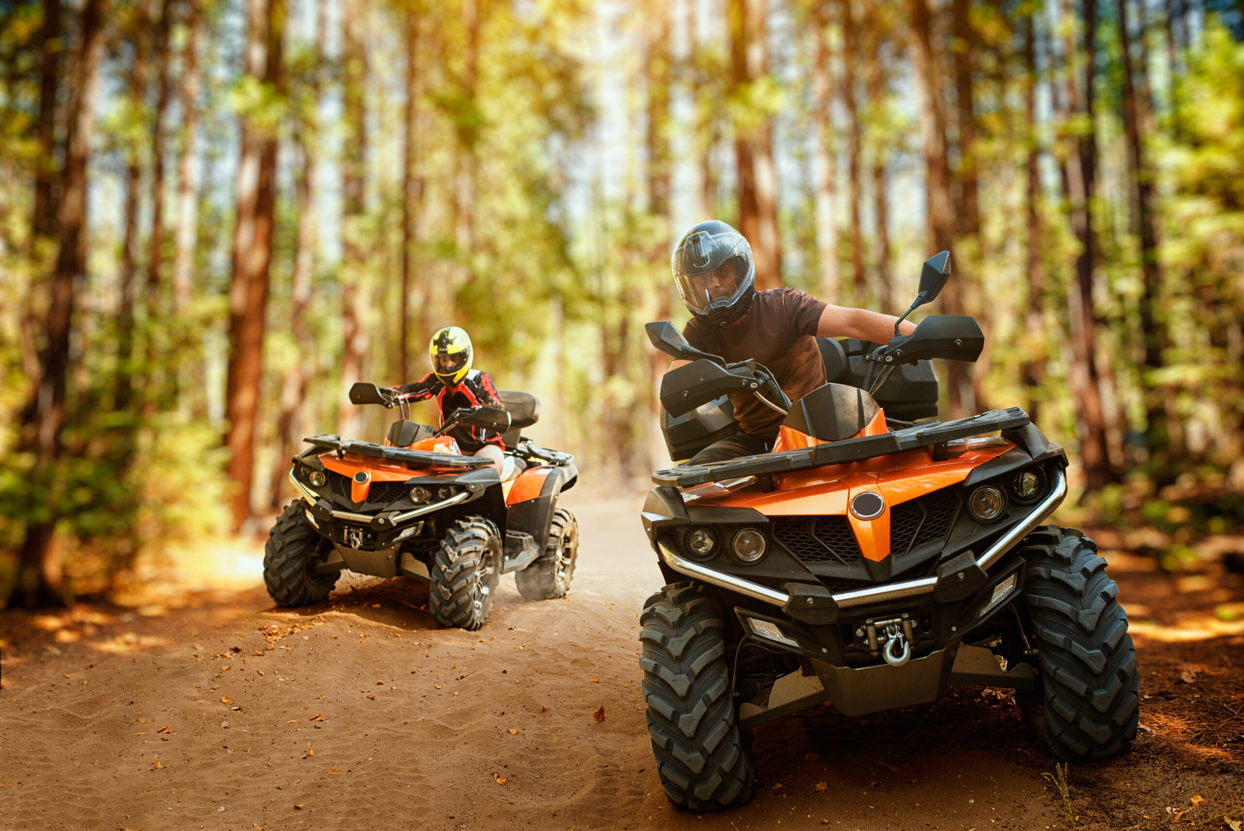 Thanks to a new ATV loan, two riders go exploring along a  Tennessee forest trail.