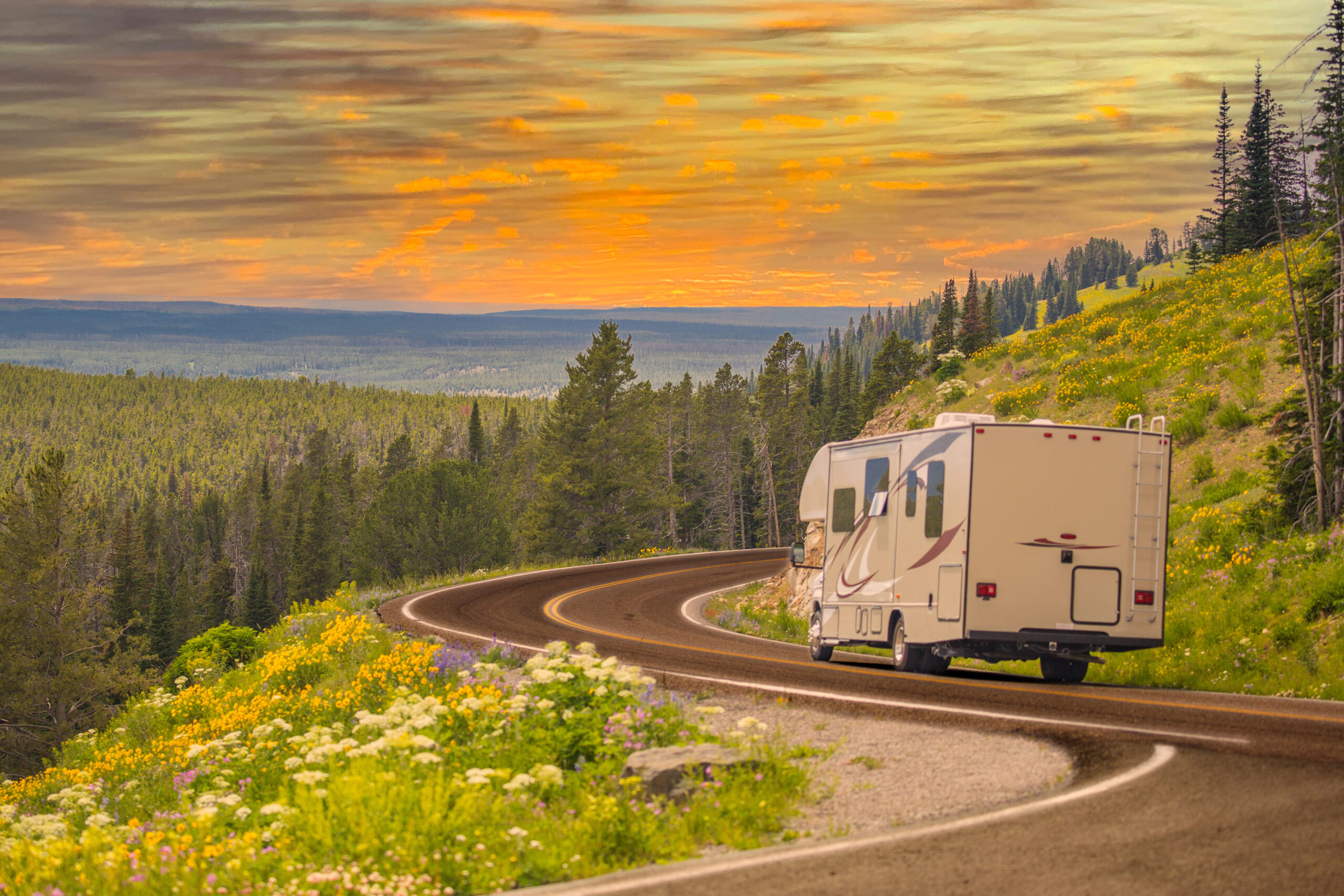 A motorhome purchased with an RV loan travels down a twisty, scenic mountain road in Tennessee.