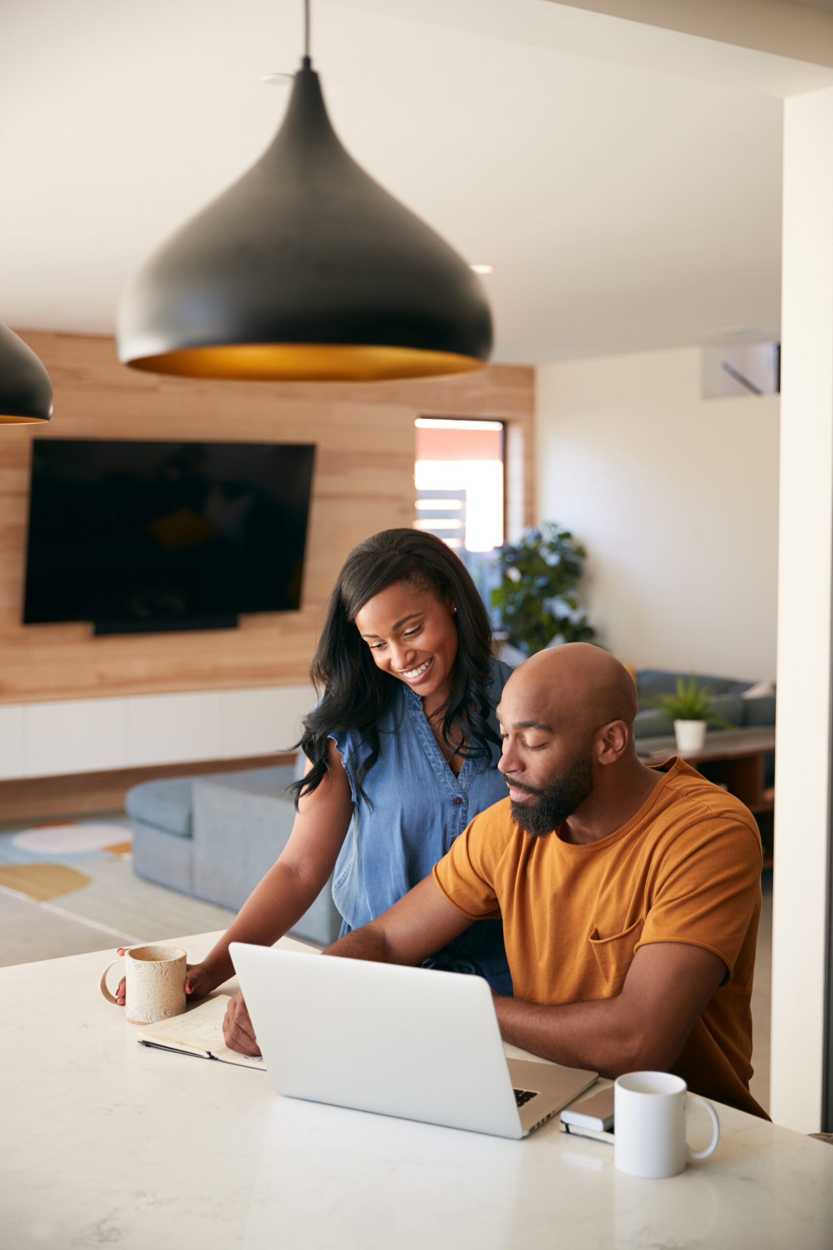 A couple discusses applying for credit union membership at home.