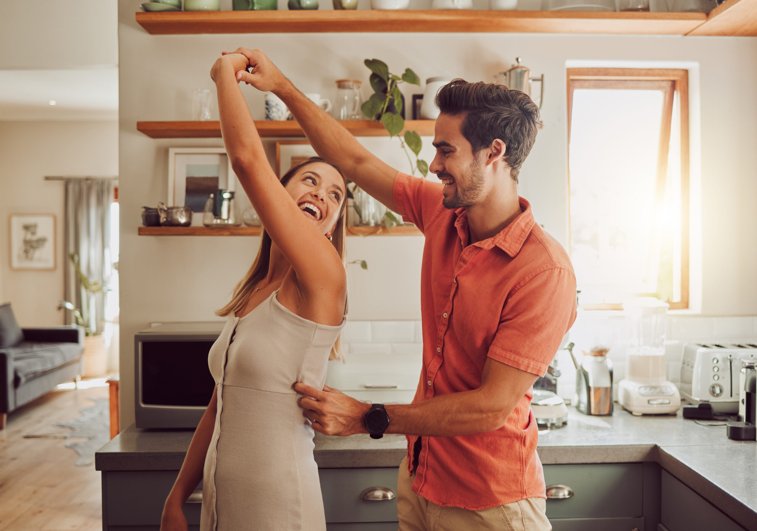 A couple dances in the kitchen that they recently remodeled with funds from a revolving line of credit.